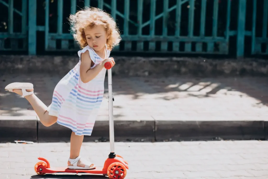 cute girl with park riding scooter