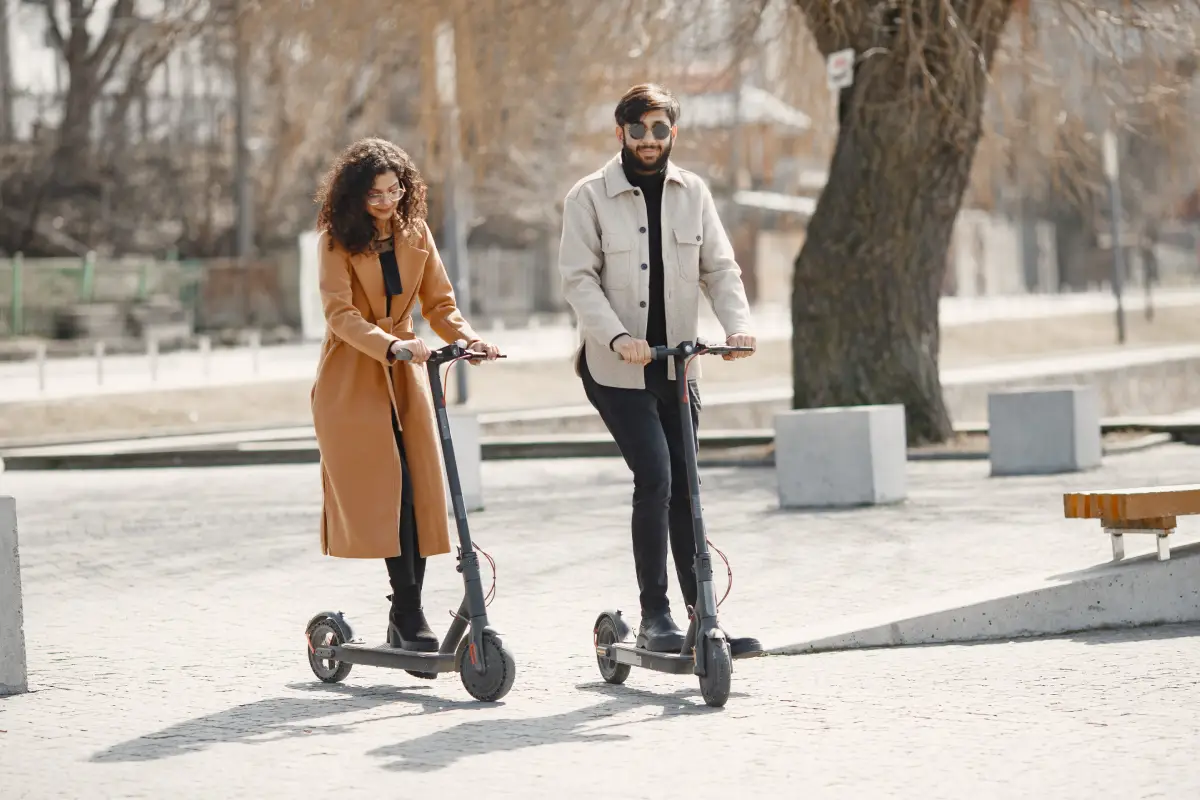 european girl anindian guy ride electric scooters