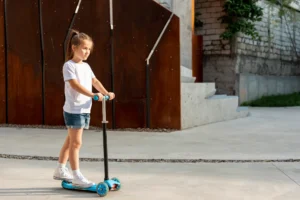 side view girl riding scoter 